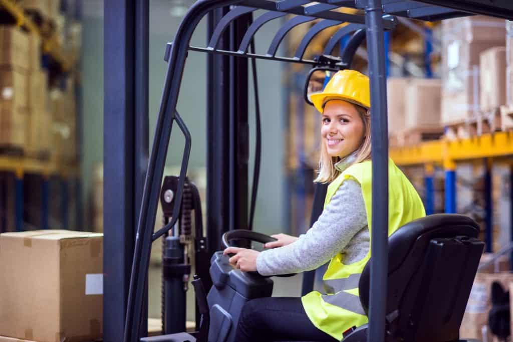 woman warehouse worker with forklift