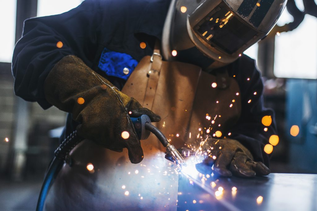 Person welding in full protective gear