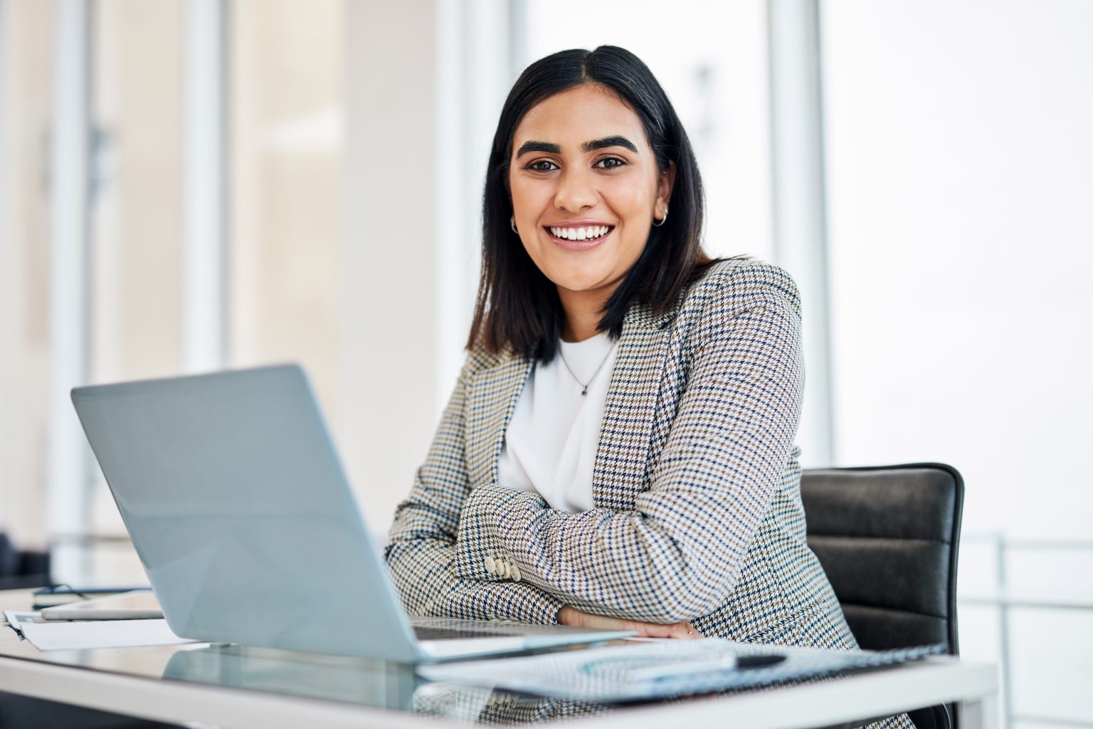 Woman sitting in front of a laptop in her office