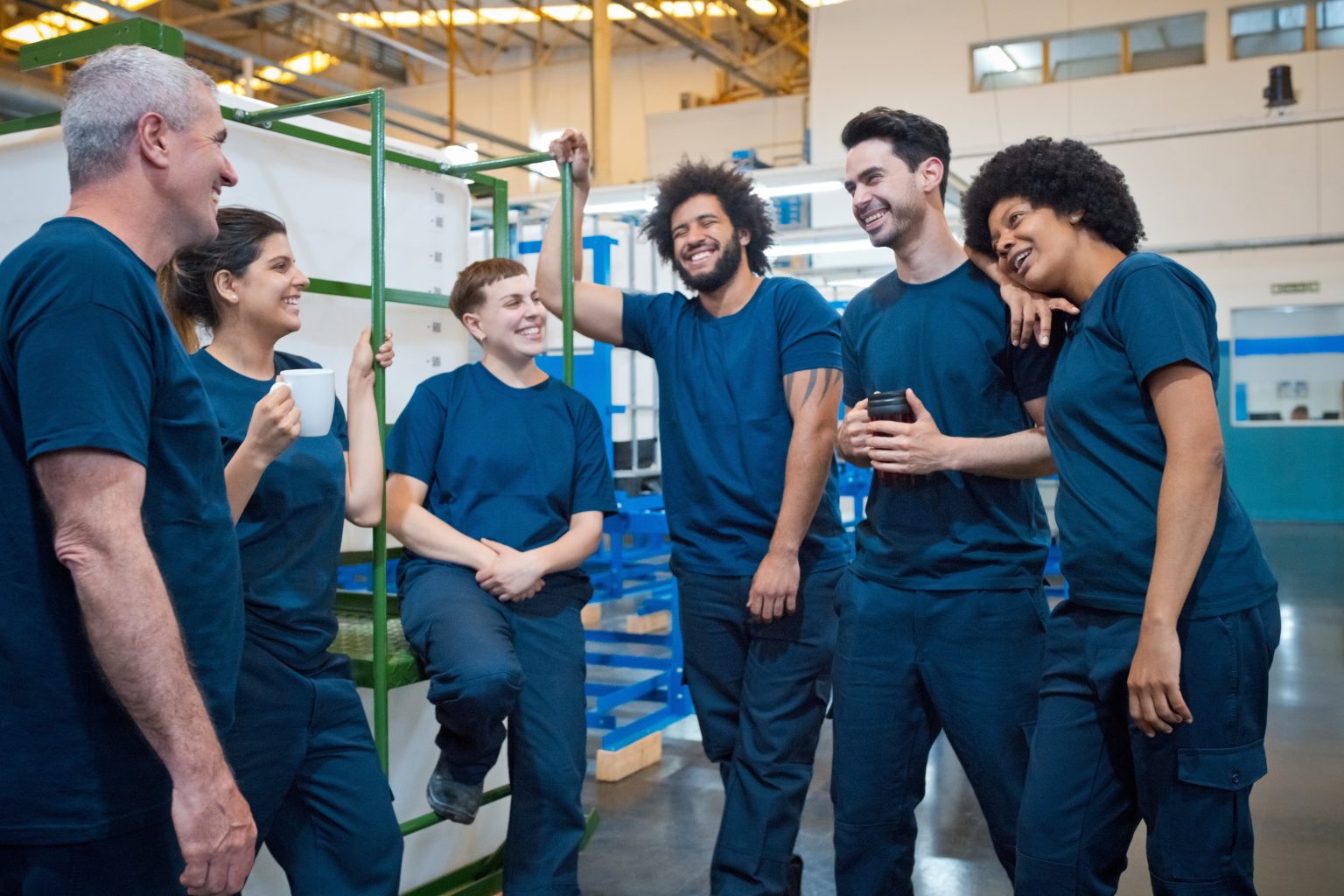 group of diverse employees in a warehouse communicating cheerfully